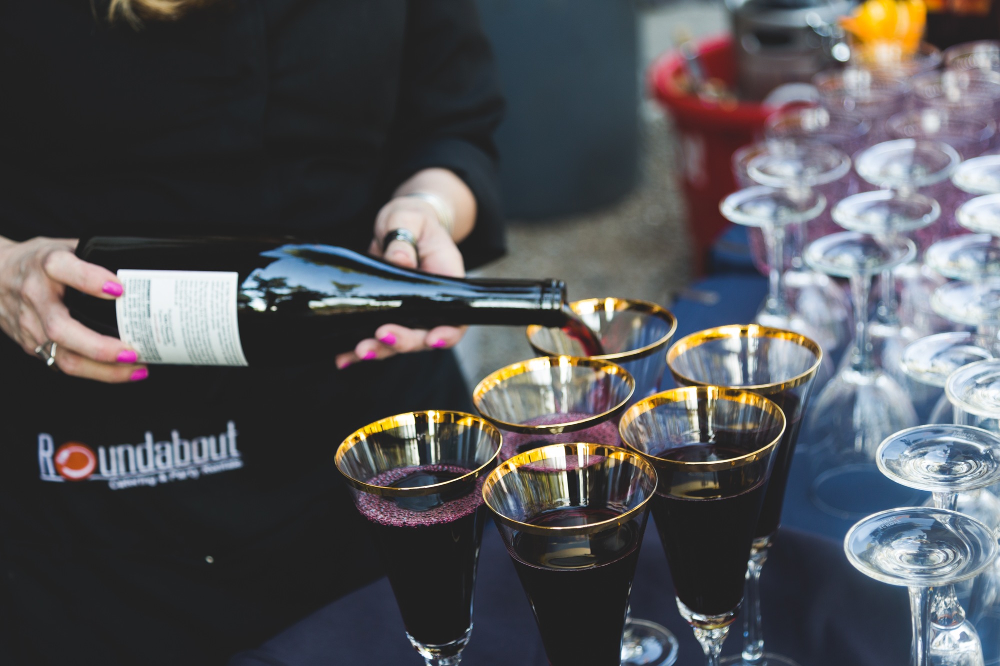 A wine pour with the Roundabout uniform visible
